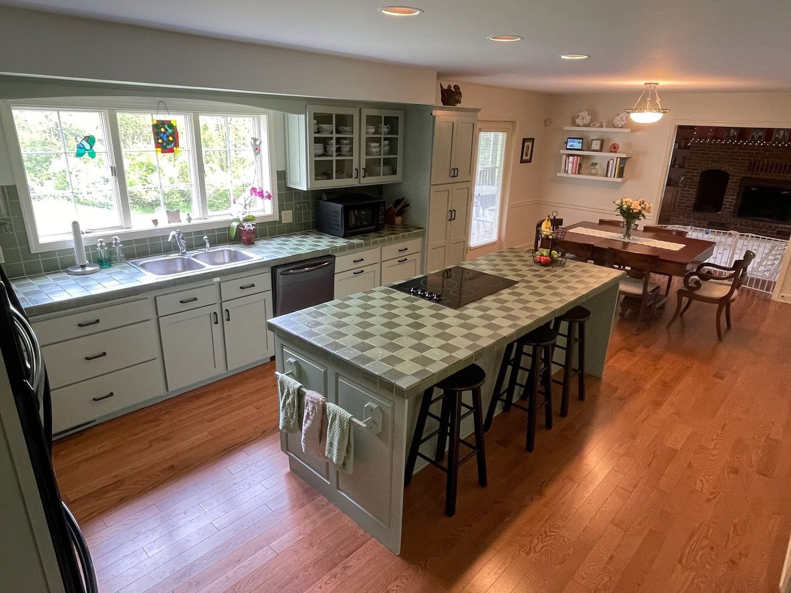 A kitchen island with stone top and seating